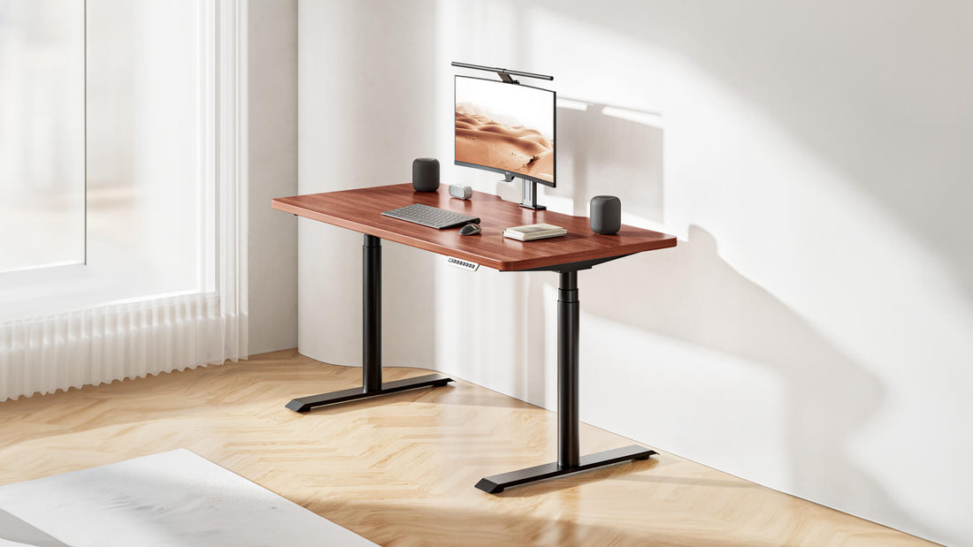 Hinomi S1 standing desk in a minimal home office setup with a monitor, keyboard, and speakers near a large window.