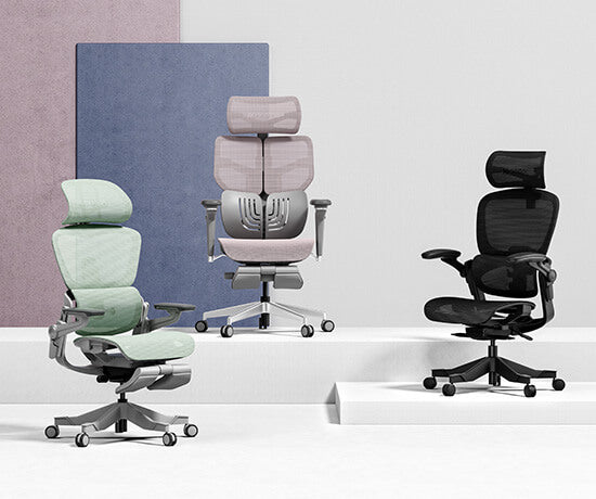 Three Hinomi ergonomic chairs in different colors displayed in a modern studio setting.