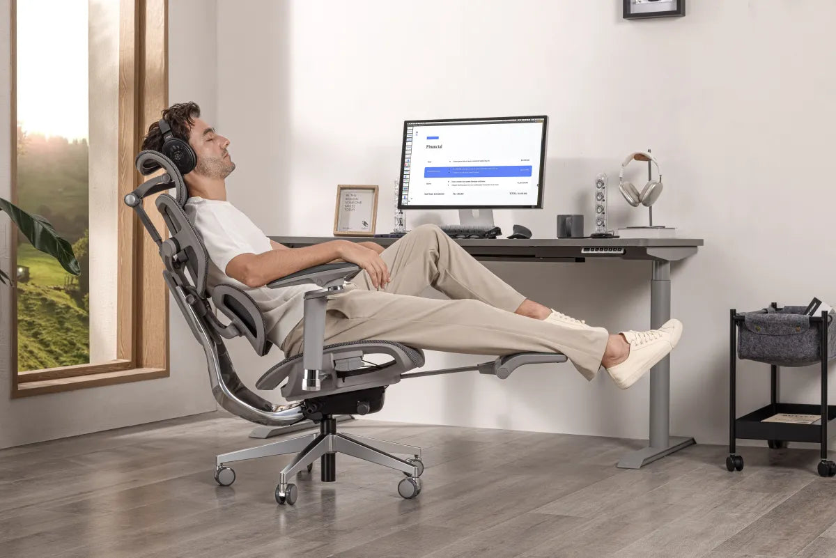 Man reclining in a Hinomi chair with headphones